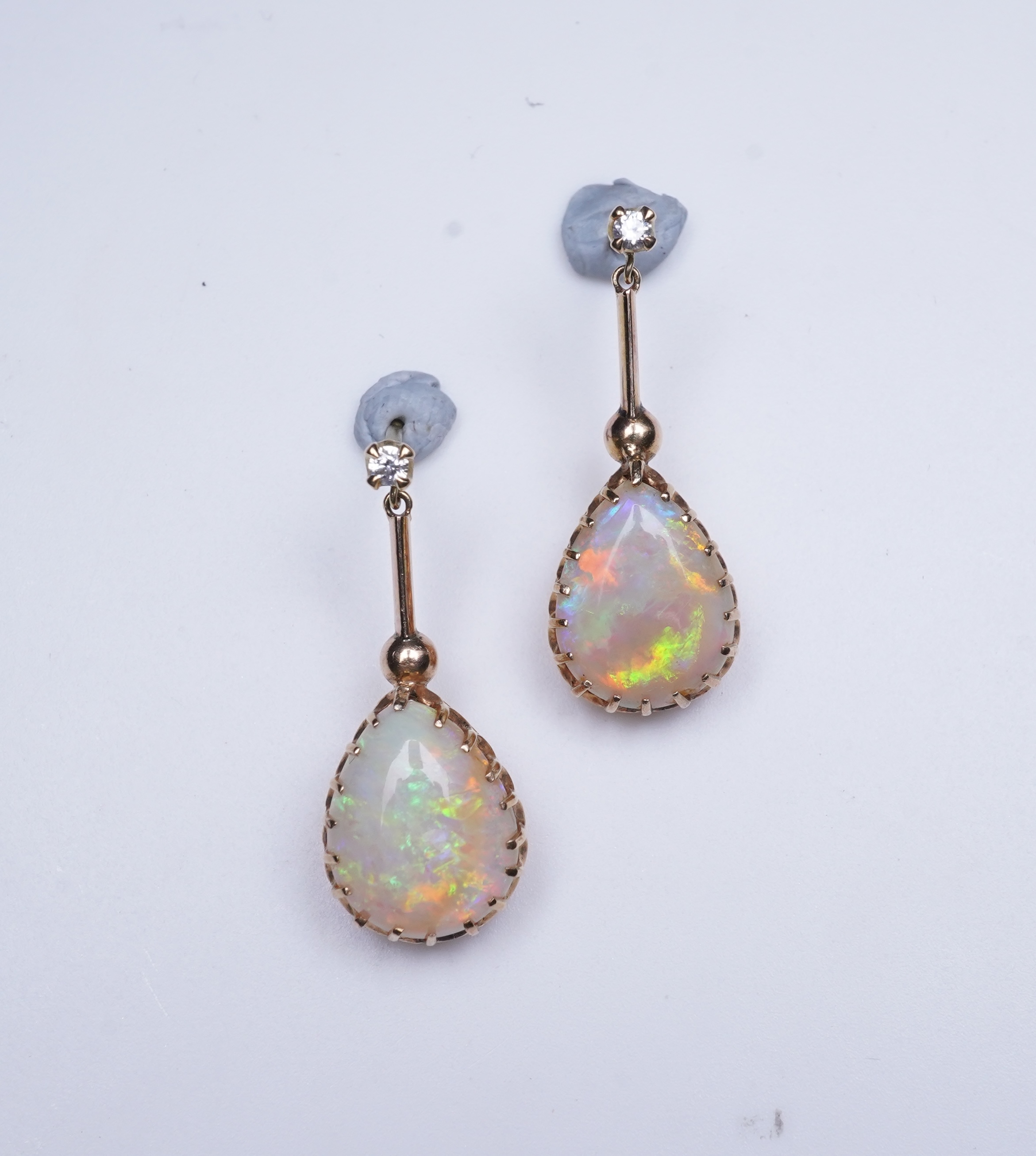 A pair of opal and diamond earrings